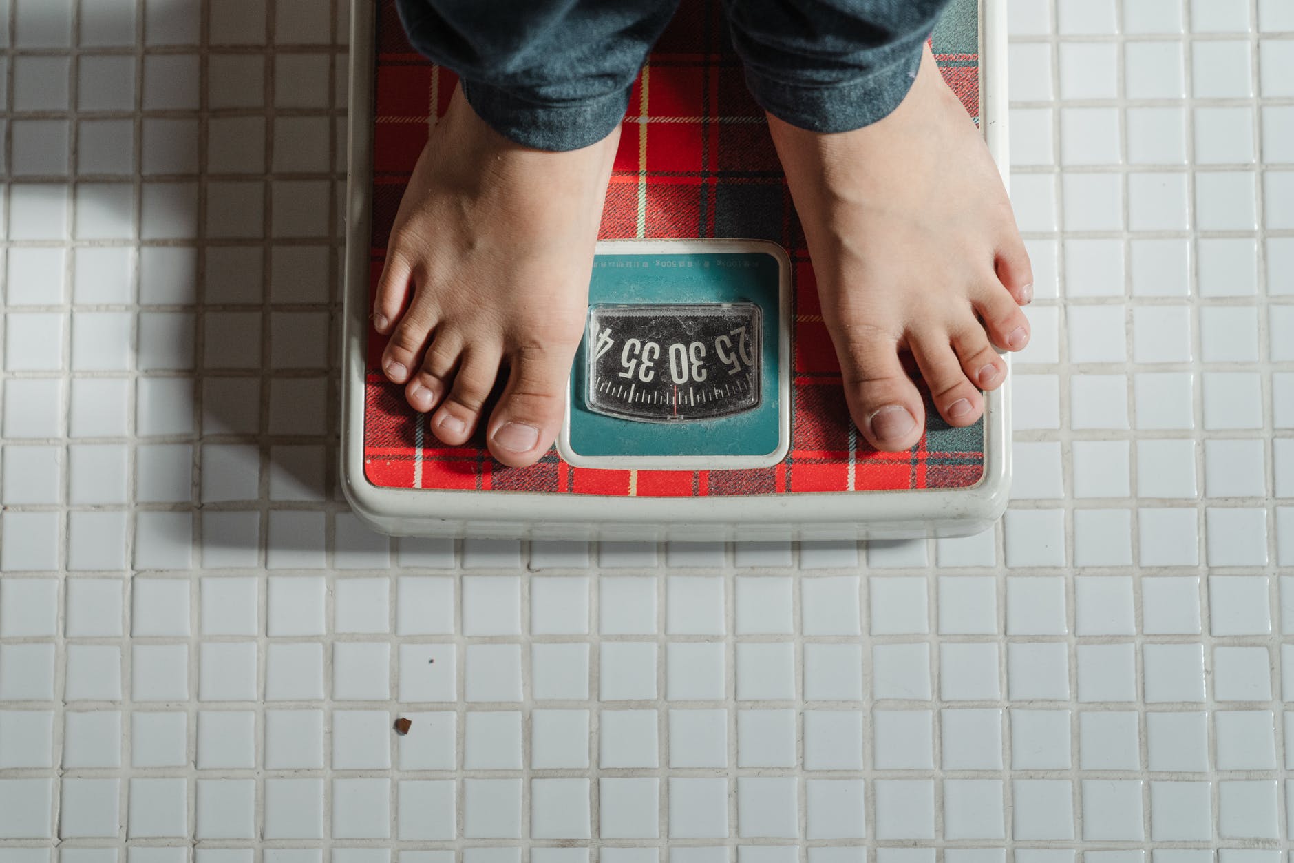 pexels-photo-4474052 crop kid weighing on scale